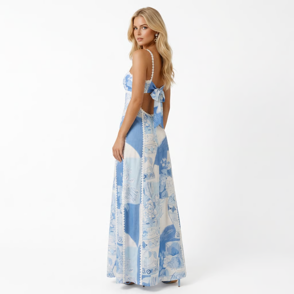 Blue mosaic print maxi dress with flowing hem and bow — back view showcasing details