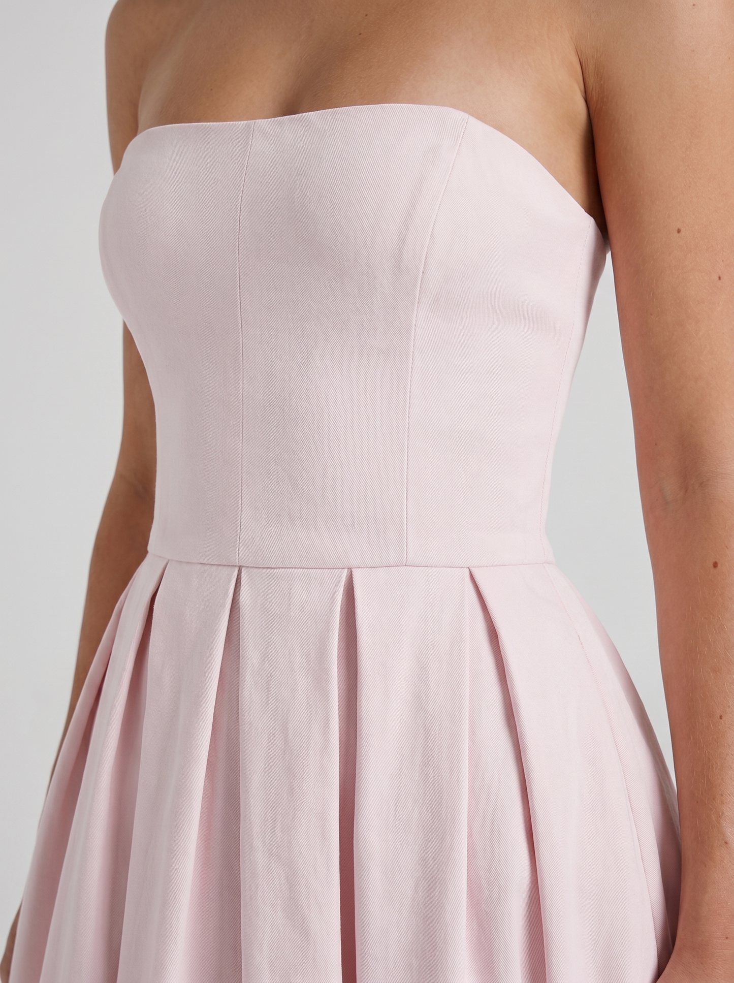 Women blush strapless pleated midi dress closeup of bodice and pleat detail