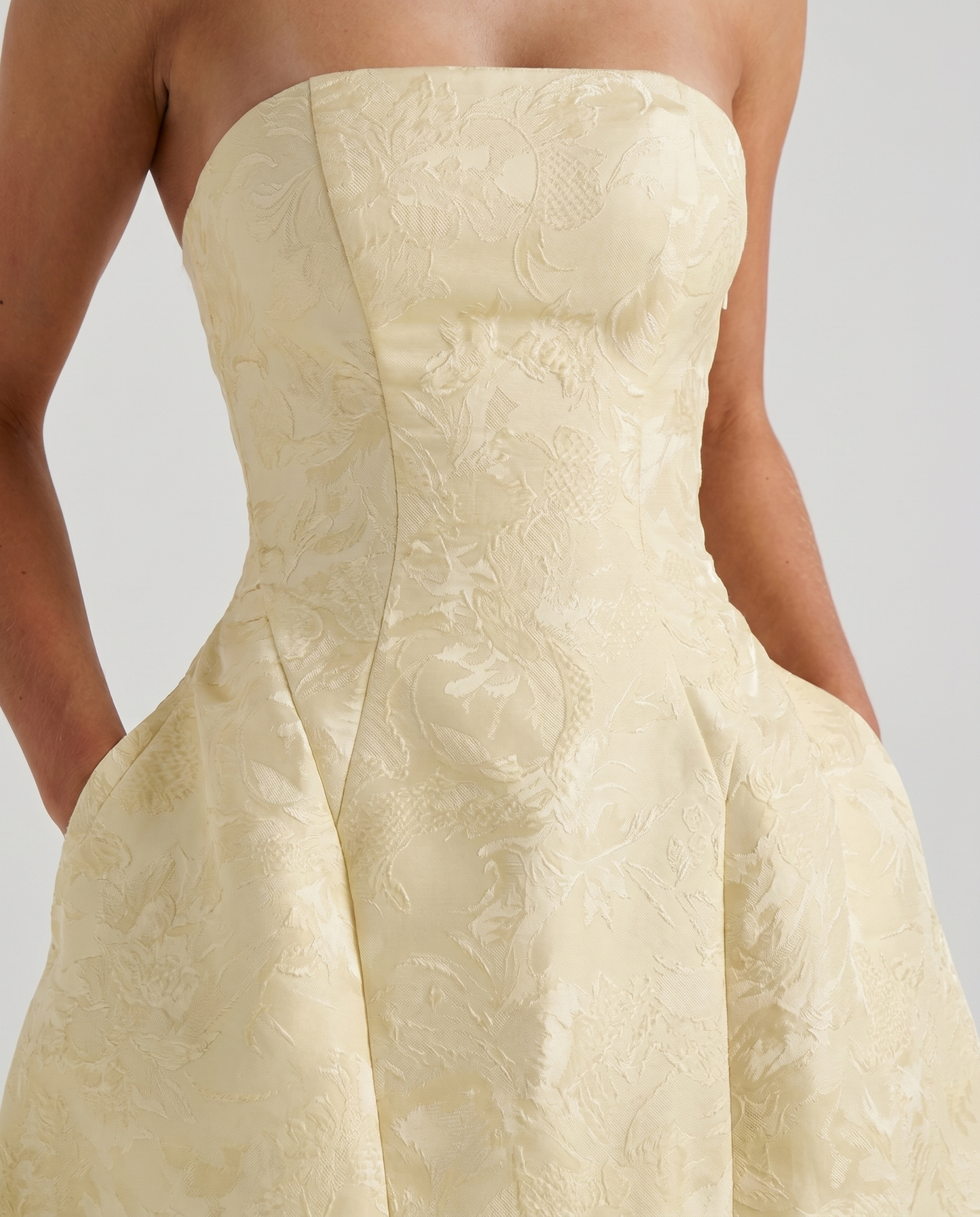 Women lemon strapless mini dress closeup of fitted bodice and straight strapless neckline