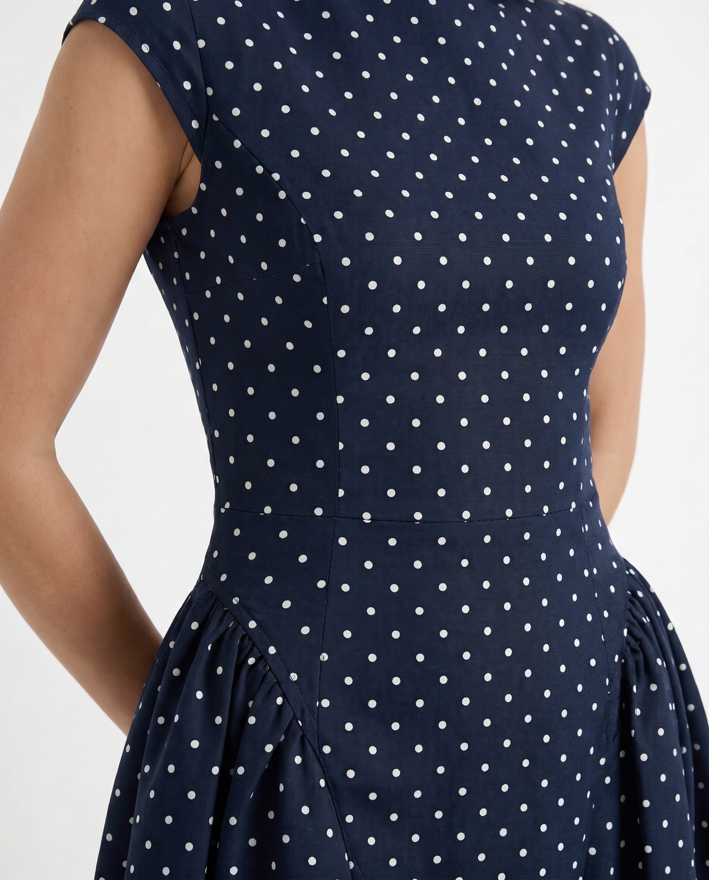 Women polka dot midi dress closeup of crew neckline, cap sleeve, and polka dot print