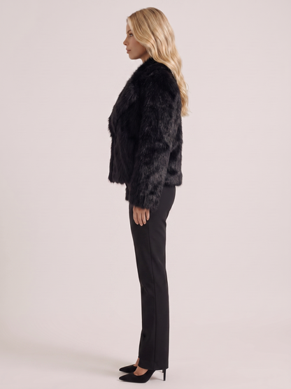Women black long pile faux fur jacket with shawl collar and open front, side view
