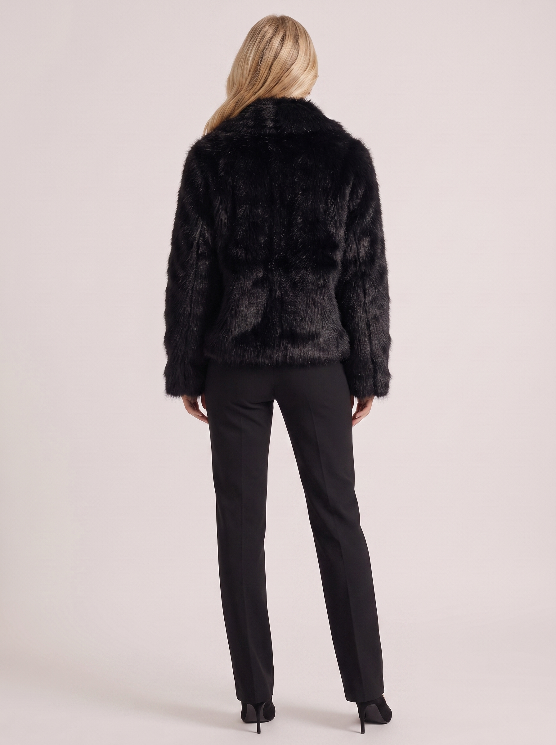 Women black long pile faux fur jacket with shawl collar and open front, back view