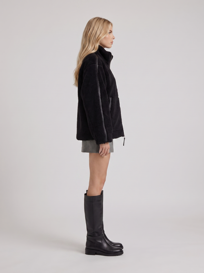 Women black oversized teddy borg jacket with stand collar and two way zip, side view