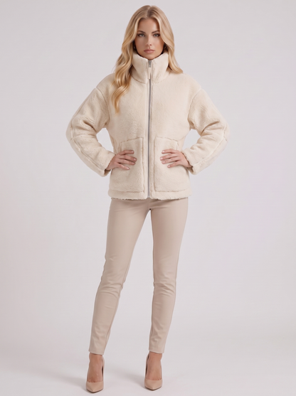 Women white oversized teddy borg jacket with stand collar and two way zip, three quarter view