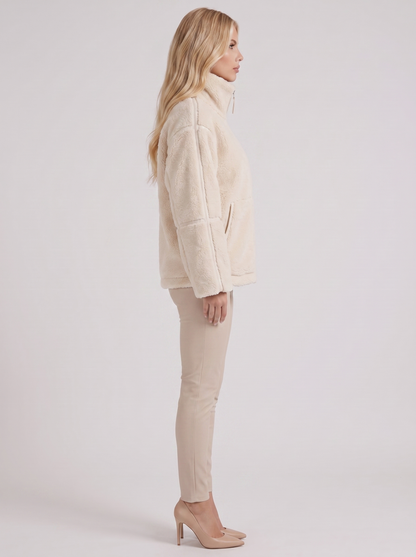 Women white oversized teddy borg jacket with stand collar and two way zip, side view