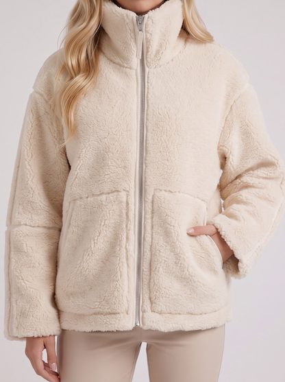 Women white oversized teddy borg jacket with stand collar and two way zip, fabric closeup