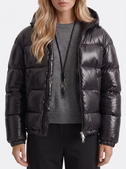 Women black cropped hooded puffer jacket with horizontal quilting and glossy finish, fabric closeup