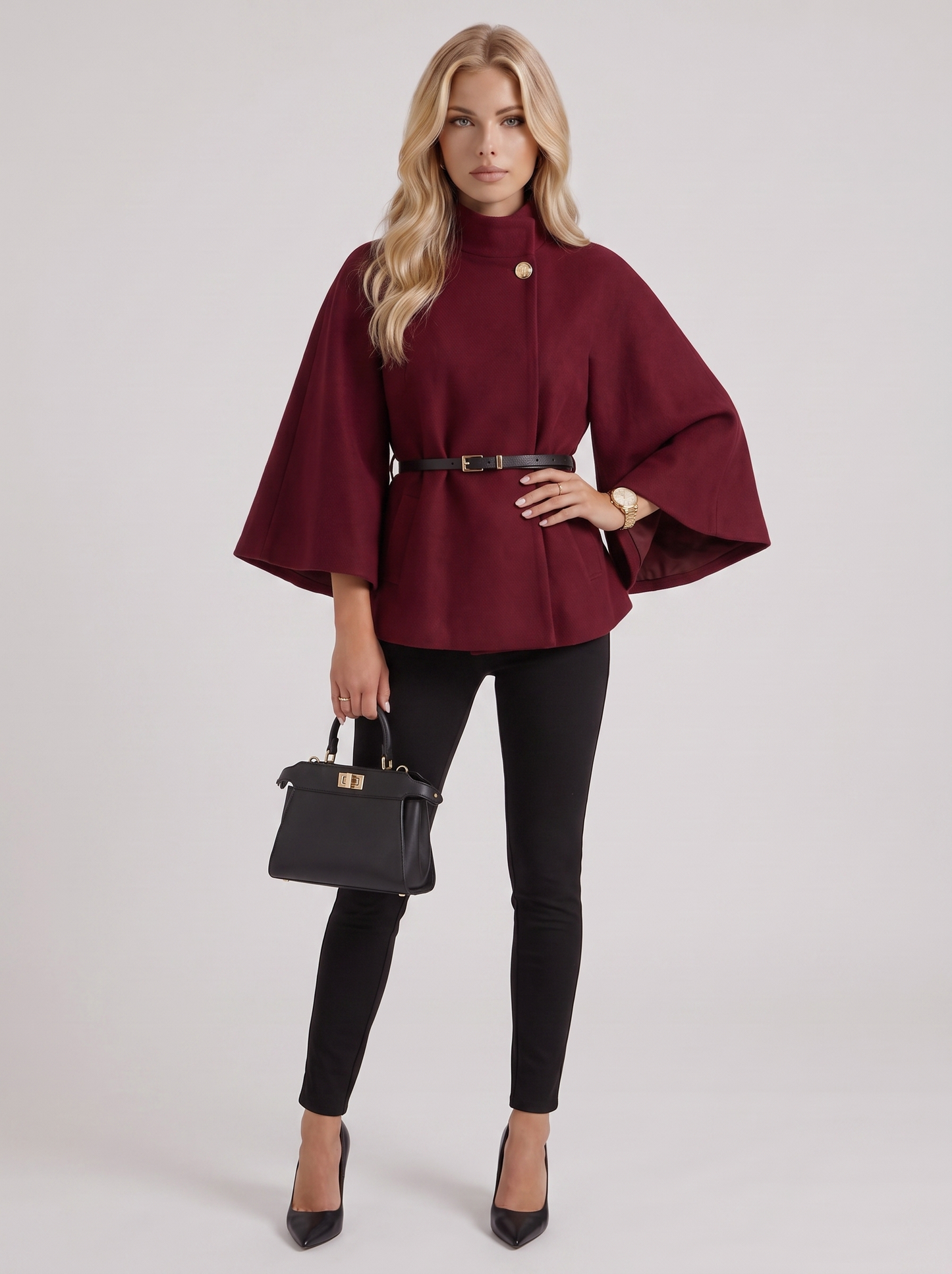 Women burgundy wool blend cape jacket with funnel neck, button fastening and slim belt, three quarter view