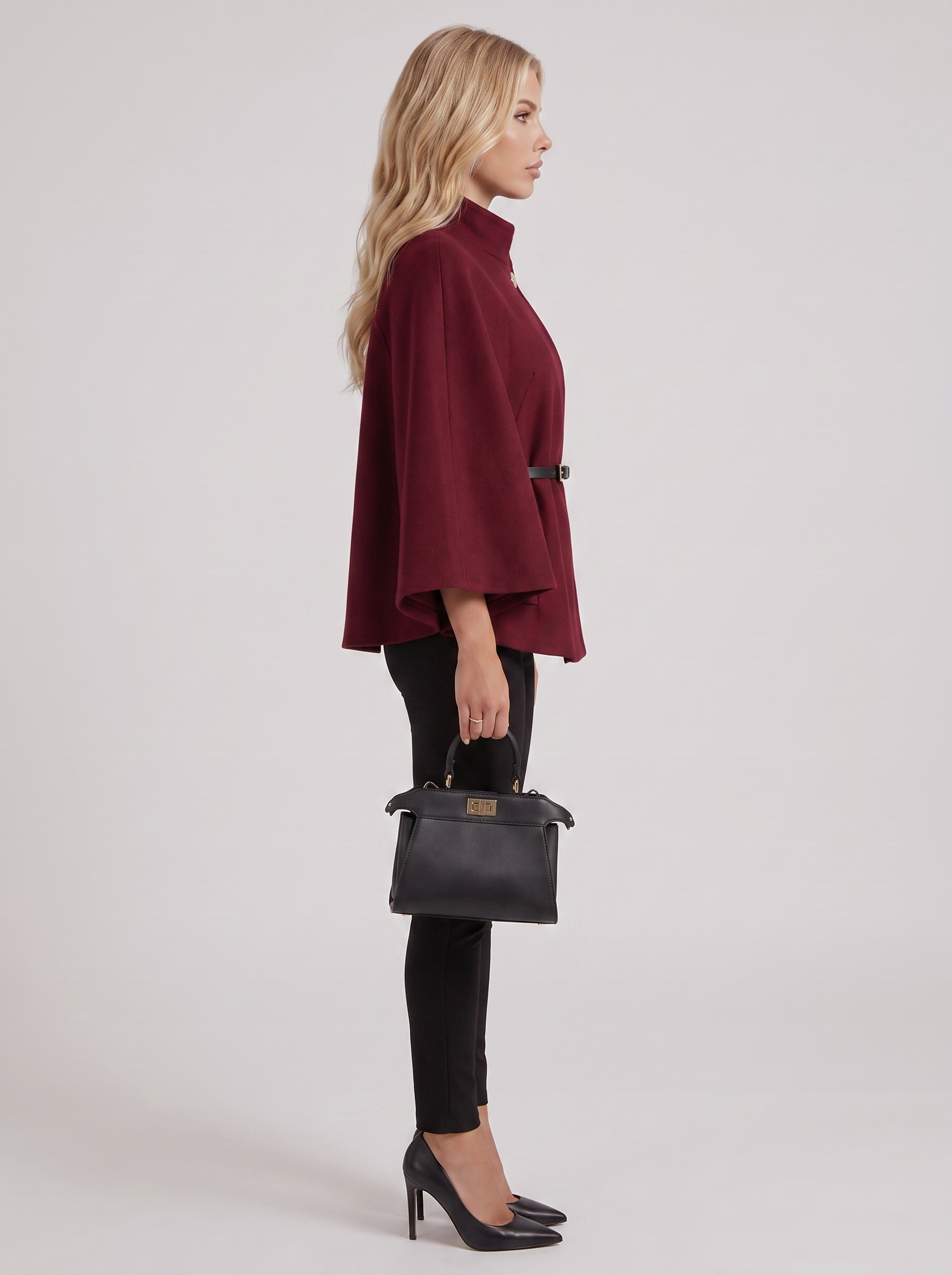Women burgundy wool blend cape jacket with funnel neck, button fastening and slim belt, side view