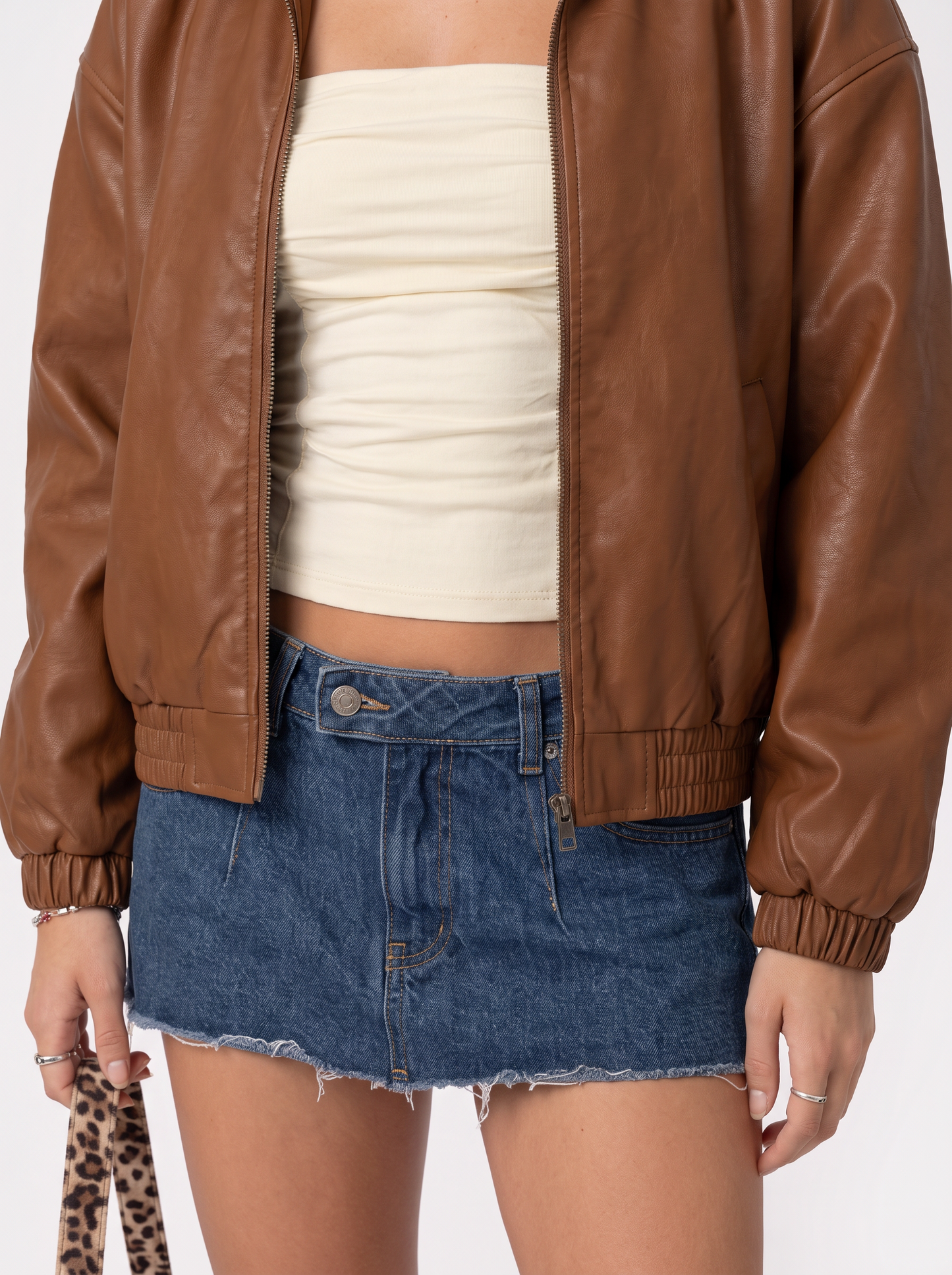 Women brown oversized faux leather bomber jacket with point collar and ribbed cuffs, fabric closeup