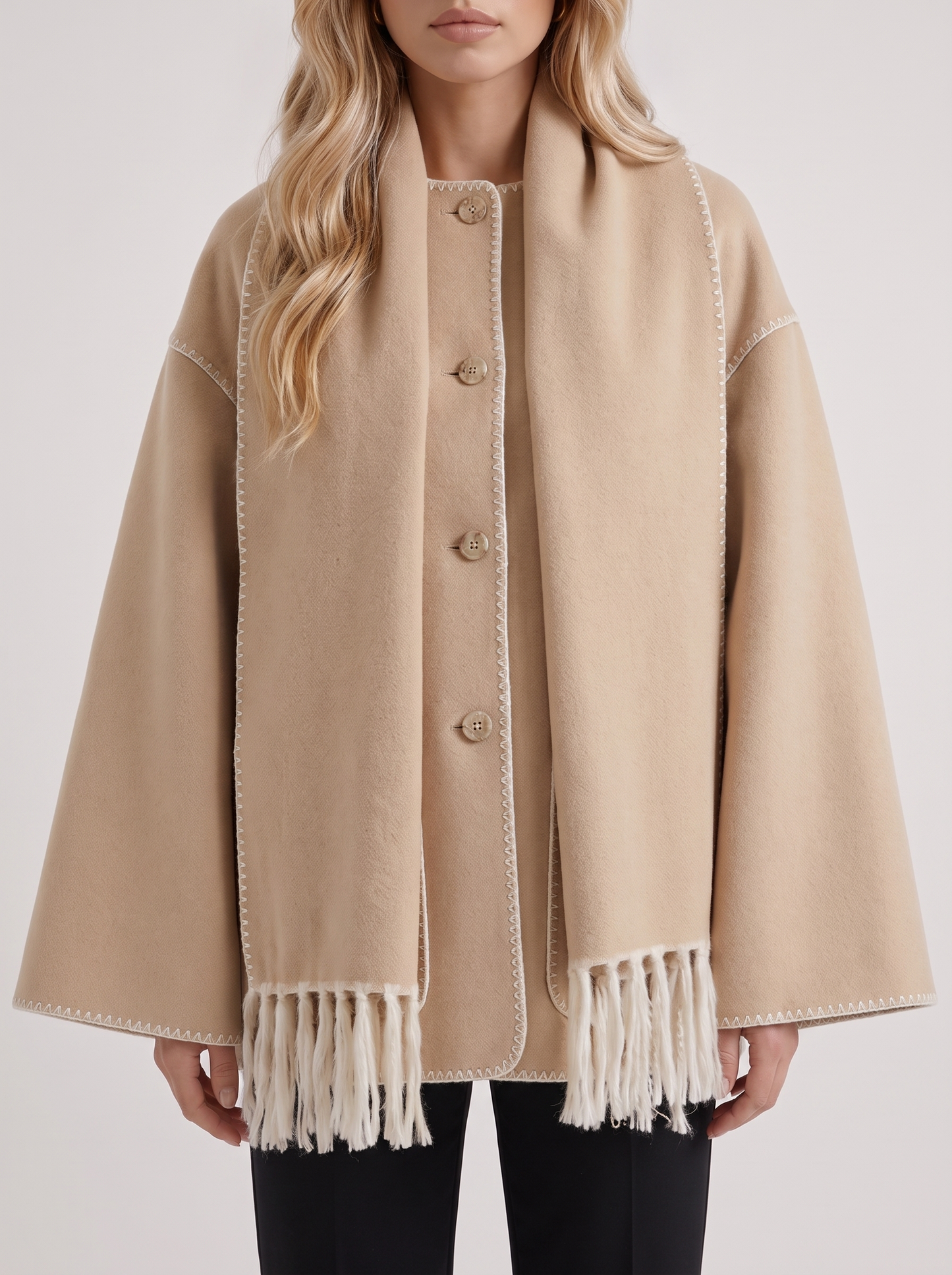 Women beige wool blend coat with attached fringed scarf and blanket stitch edges, fabric closeup