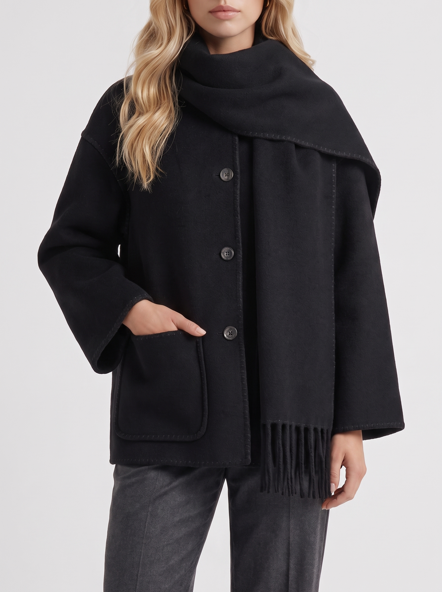 Women black wool blend coat with attached fringed scarf and blanket stitch edges, fabric closeup