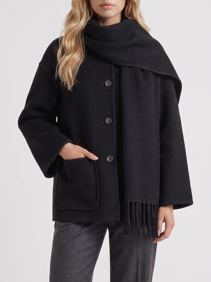 Women black wool blend coat with attached fringed scarf and blanket stitch edges, fabric closeup
