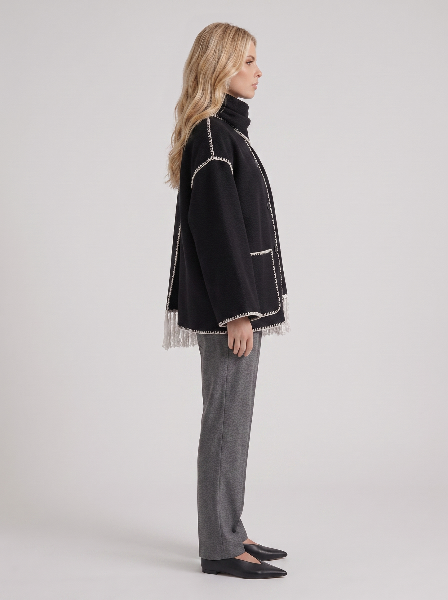 Women dark gray wool blend coat with attached fringed scarf and blanket stitch edges, side view