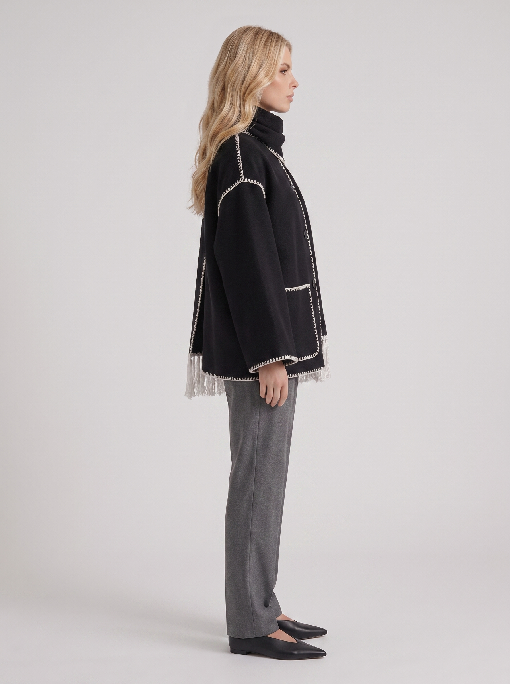 Women dark gray wool blend coat with attached fringed scarf and blanket stitch edges, side view