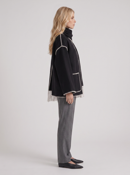 Women dark gray wool blend coat with attached fringed scarf and blanket stitch edges, side view