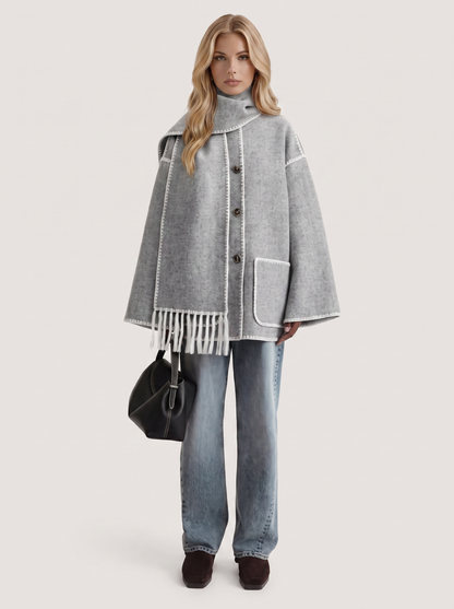 Women light gray wool blend coat with attached fringed scarf and blanket stitch edges, front view