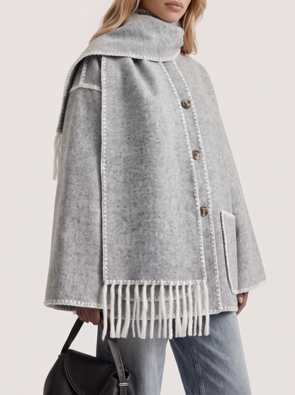 Women light gray wool blend coat with attached fringed scarf and blanket stitch edges, fabric closeup