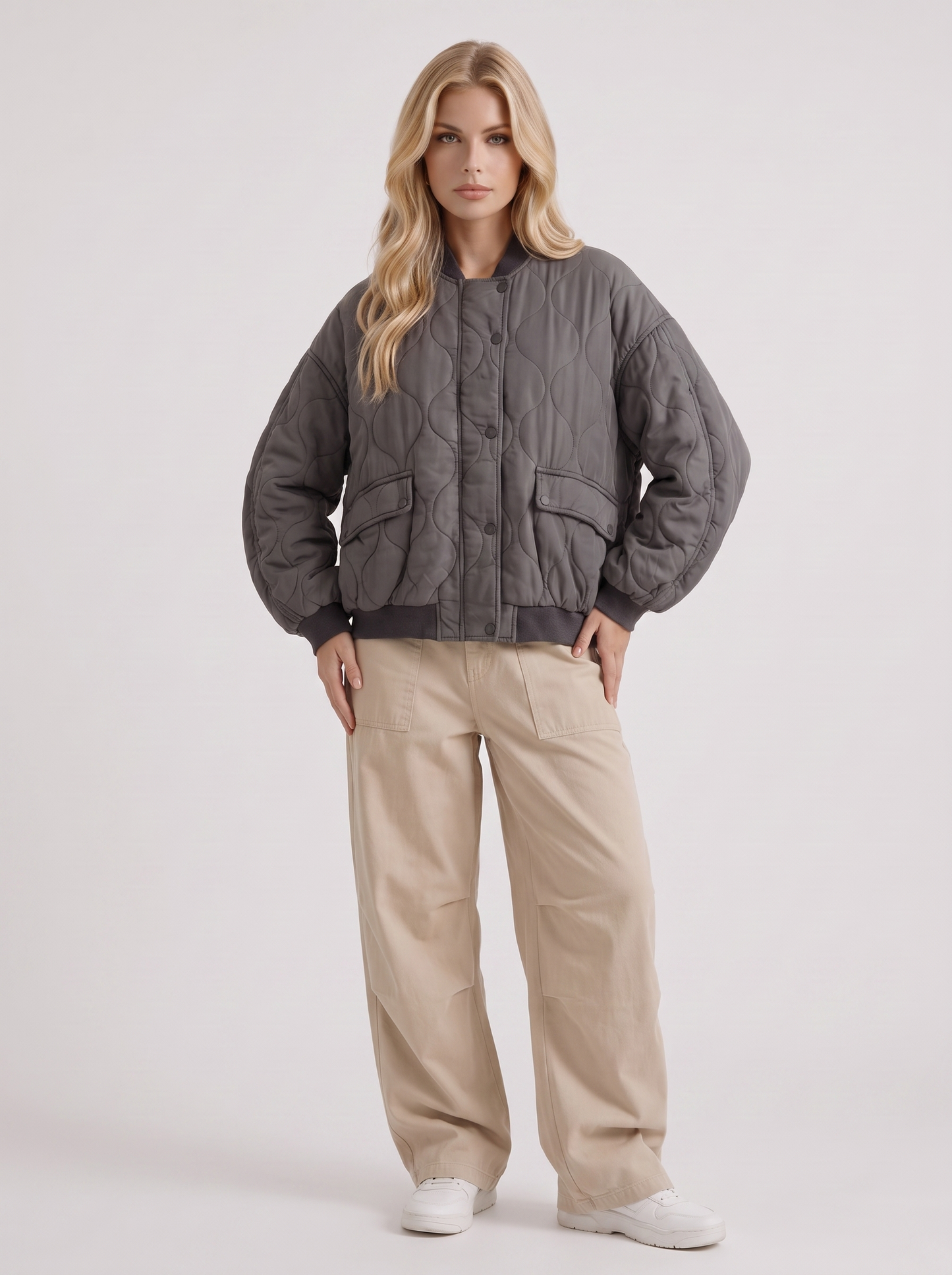 Women charcoal oversized onion quilted bomber jacket with snap front and ribbed trims, three quarter view