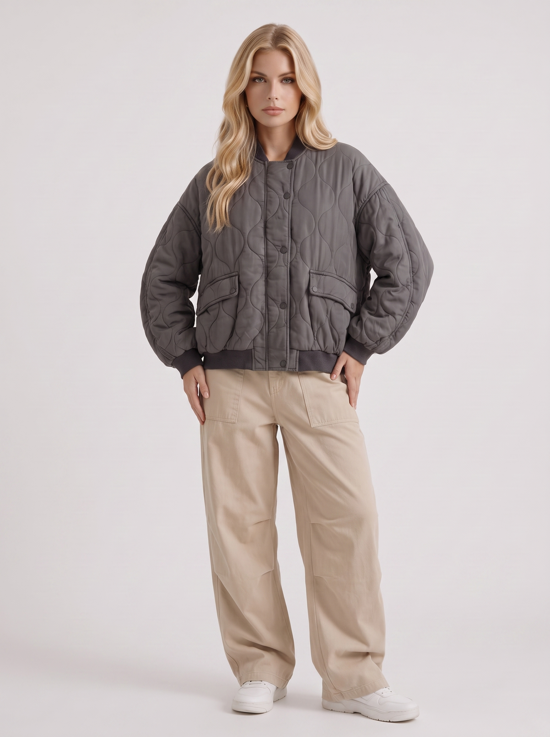 Women charcoal oversized onion quilted bomber jacket with snap front and ribbed trims, three quarter view