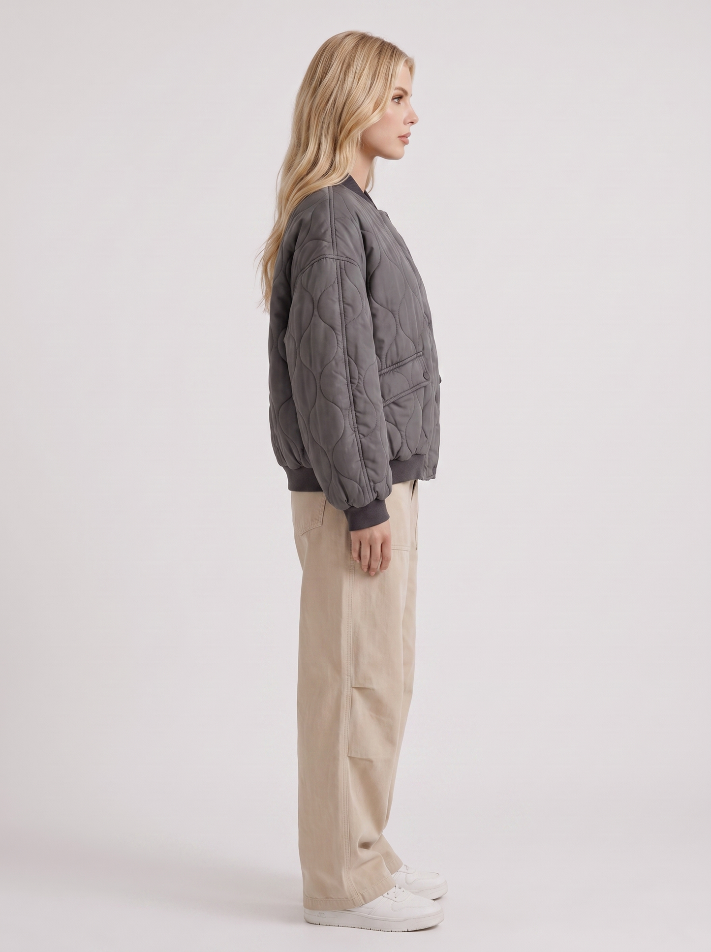 Women charcoal oversized onion quilted bomber jacket with snap front and ribbed trims, side view