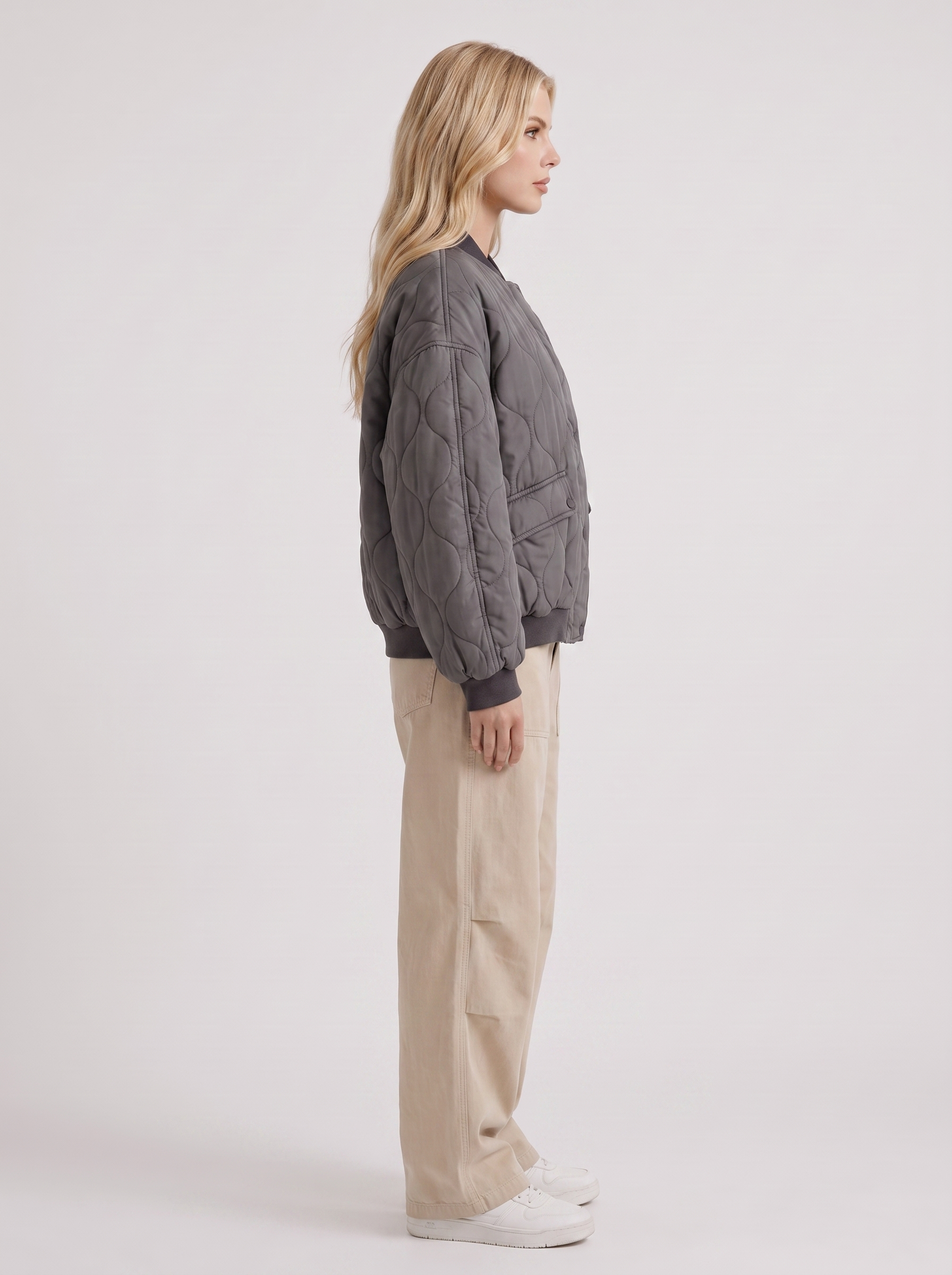 Women charcoal oversized onion quilted bomber jacket with snap front and ribbed trims, side view