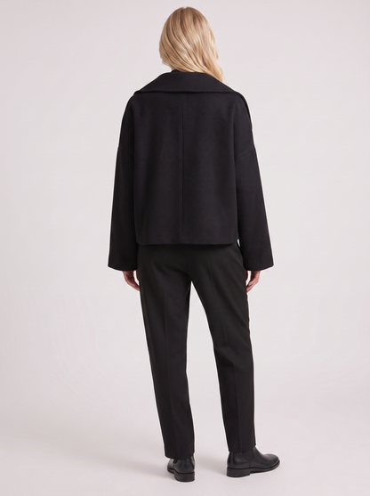 Women black oversized double breasted wool blend peacoat with wide notch collar, back view
