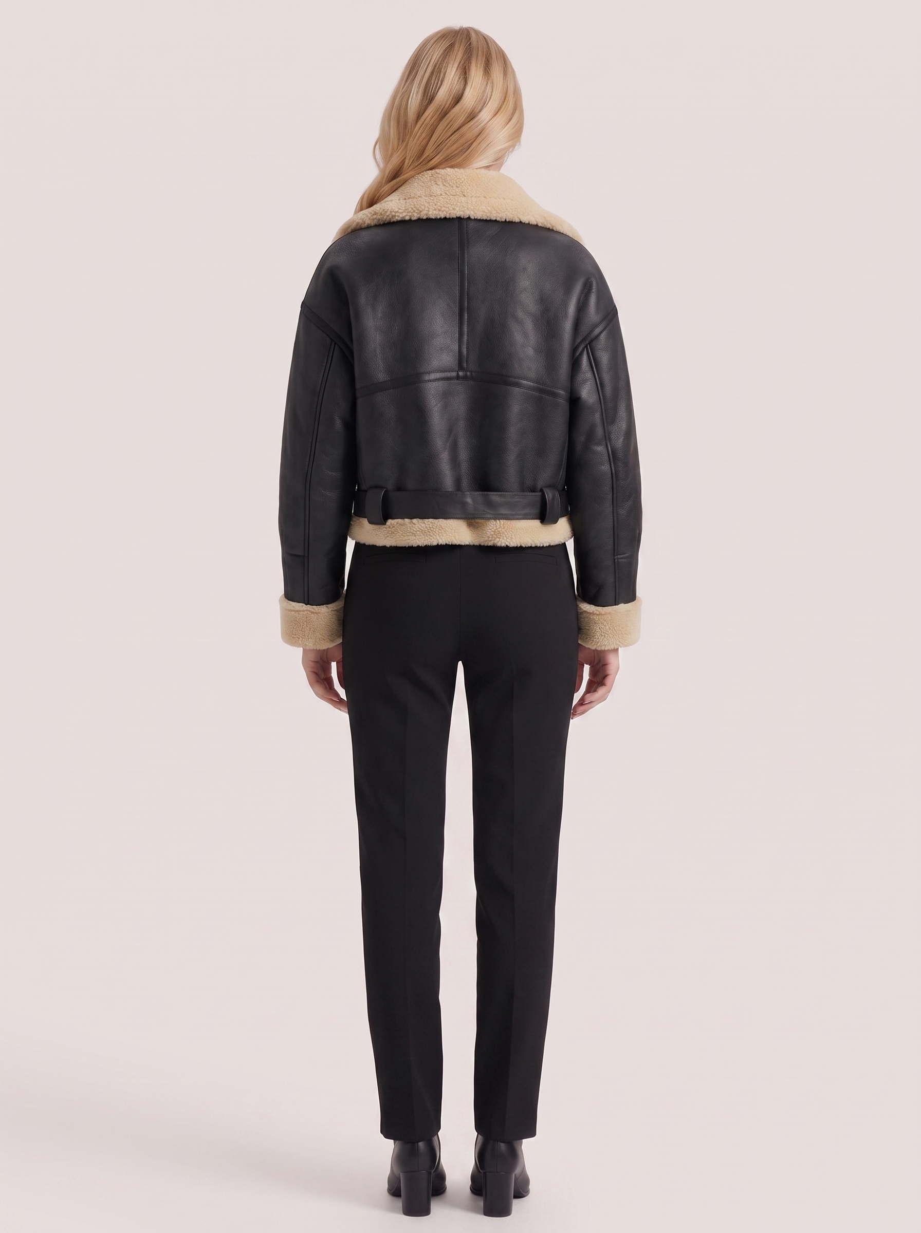 Women black cropped faux leather aviator jacket with faux shearling collar and belt, back view