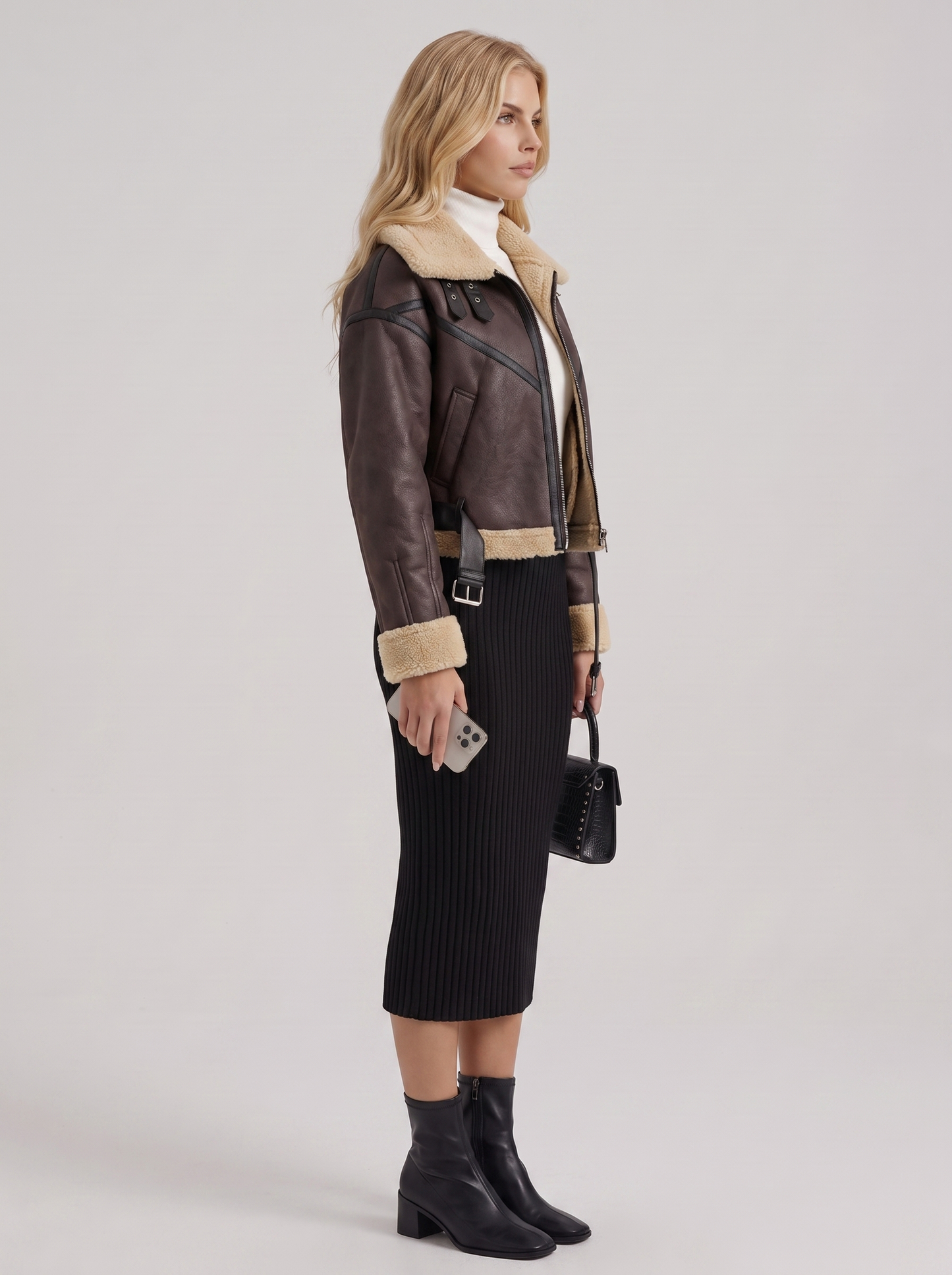 Women brown cropped faux leather aviator jacket with faux shearling collar and belt, side view