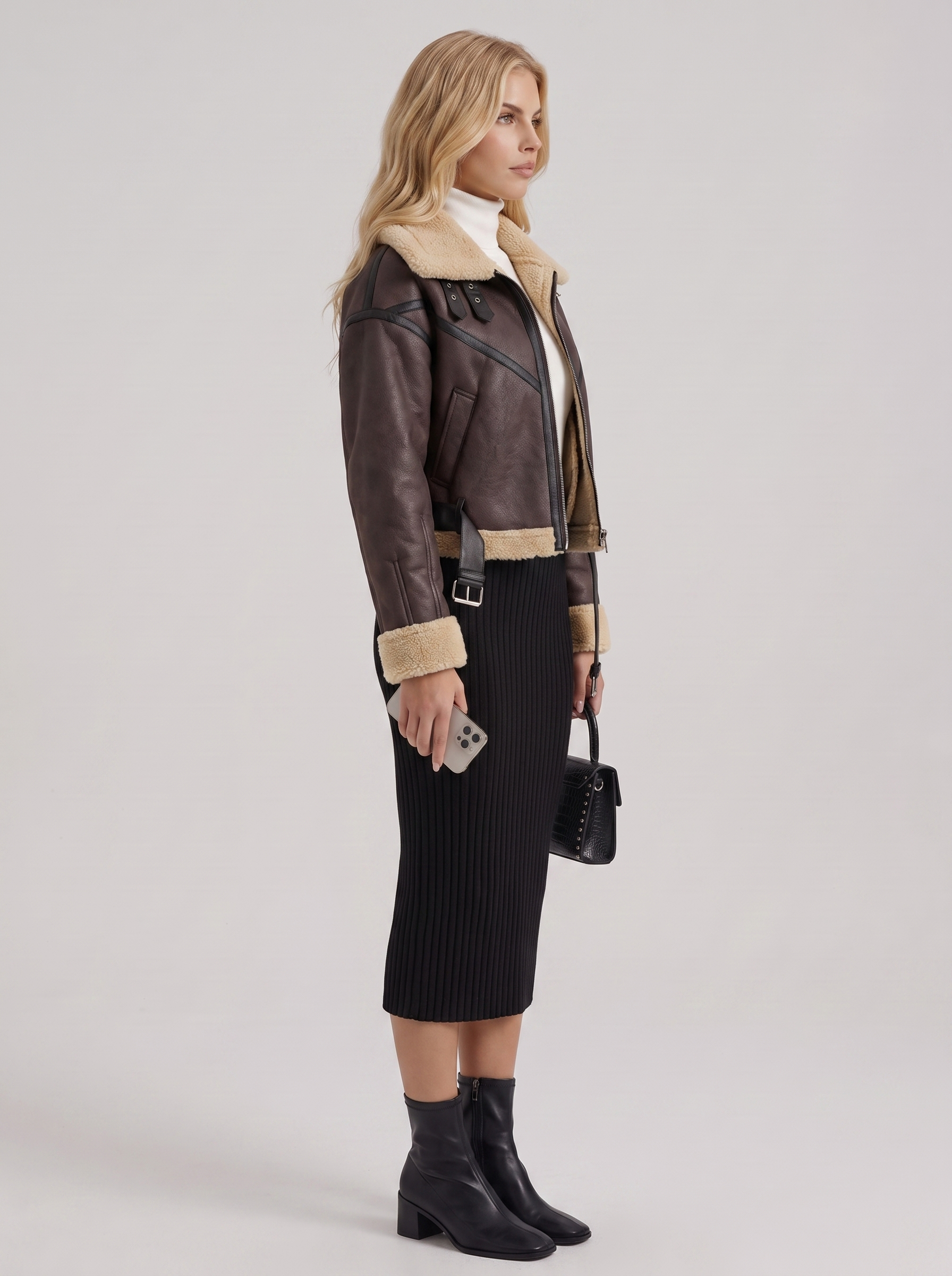 Women brown cropped faux leather aviator jacket with faux shearling collar and belt, side view
