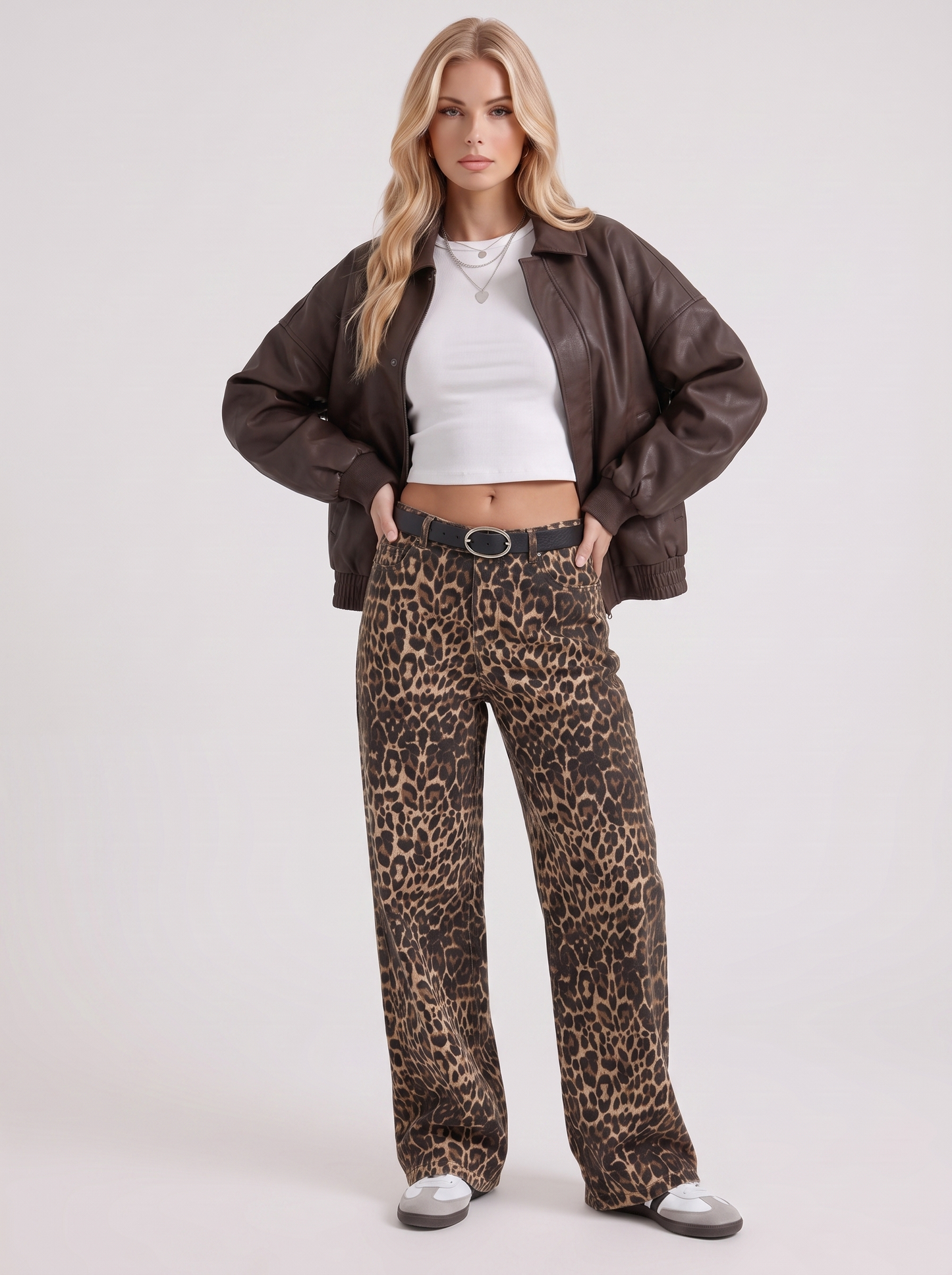 Women brown oversized faux leather bomber jacket with point collar and snap placket, three quarter view