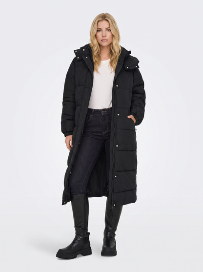 Women black longline hooded puffer coat with horizontal quilting and zip front, front view