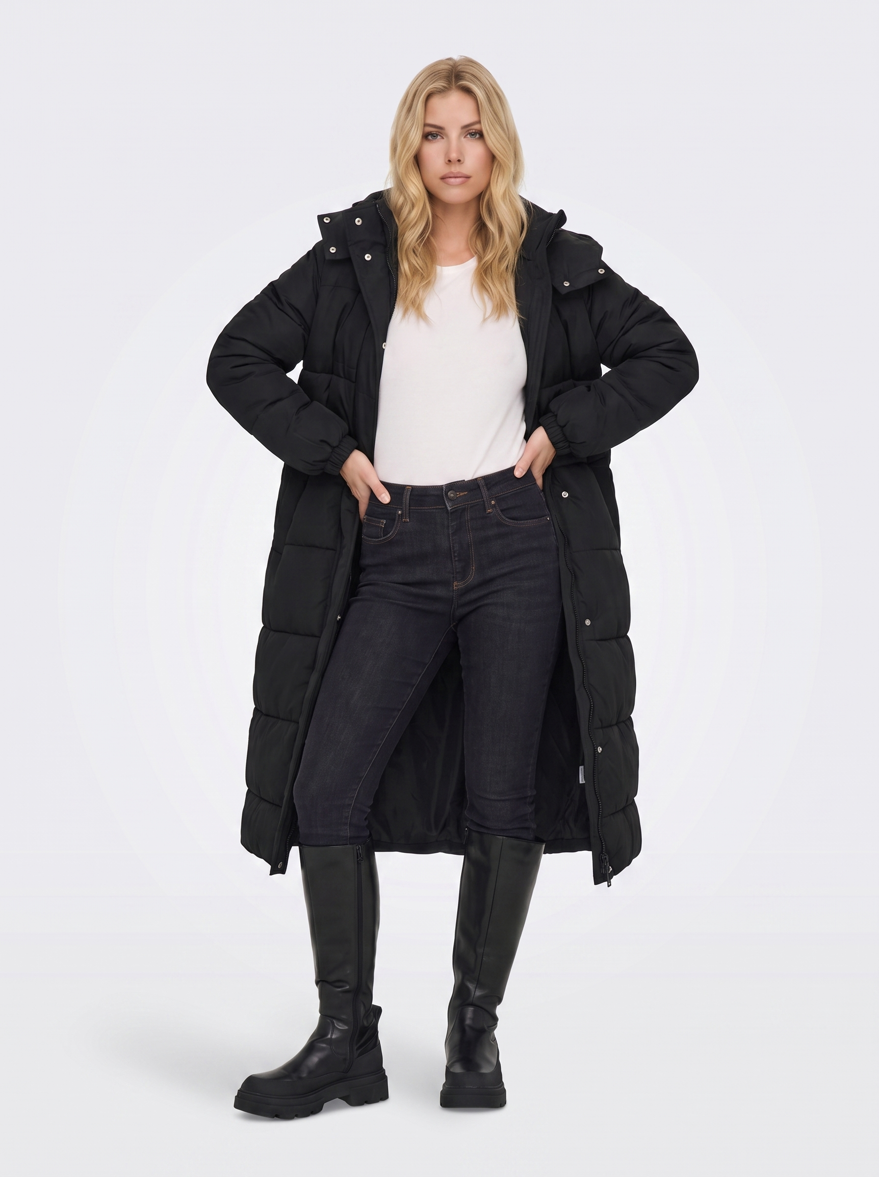 Women black longline hooded puffer coat with horizontal quilting and zip front, three quarter view