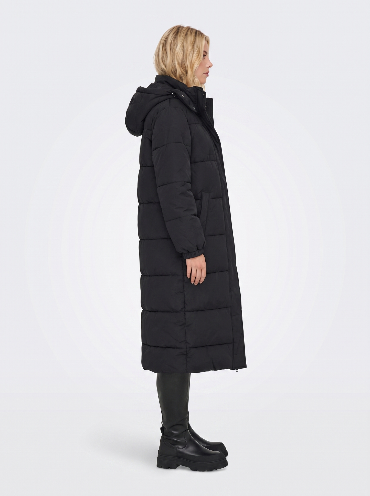 Women black longline hooded puffer coat with horizontal quilting and zip front, side view