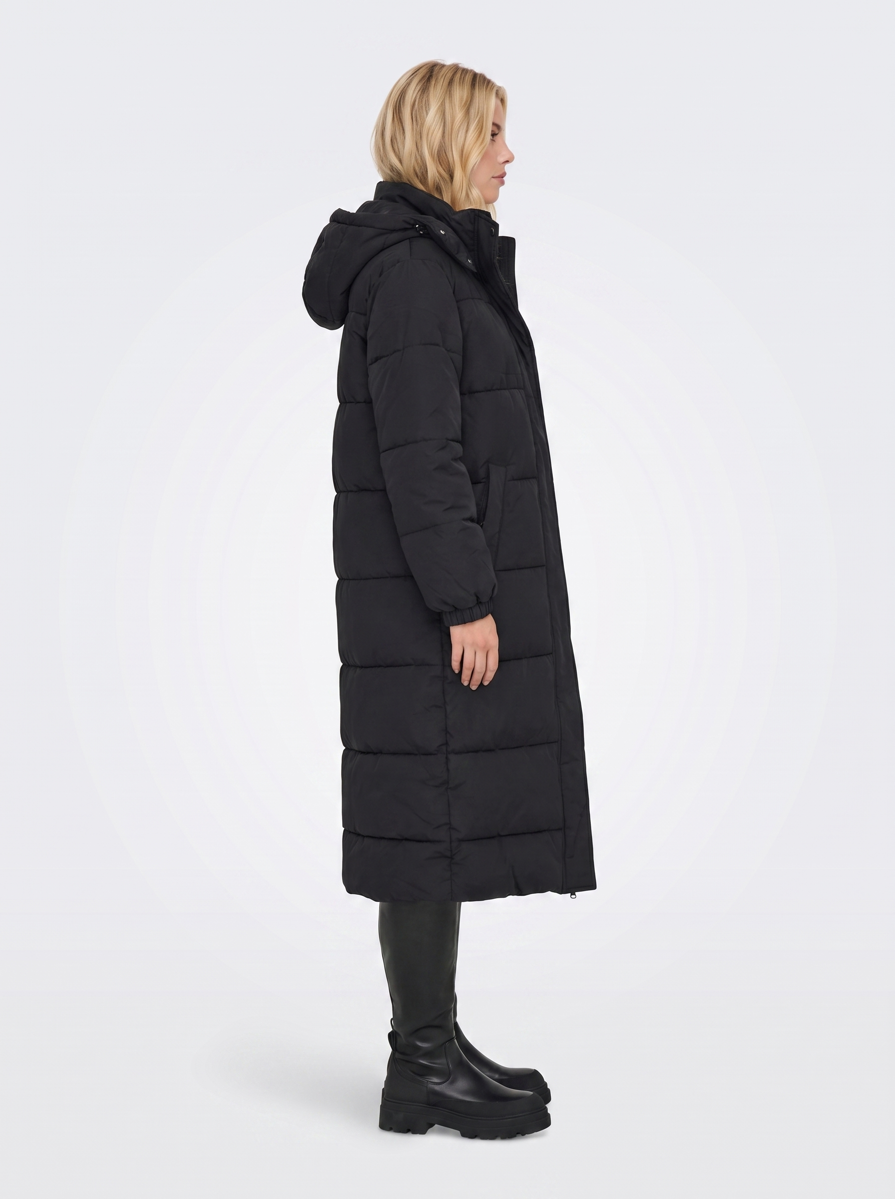 Women black longline hooded puffer coat with horizontal quilting and zip front, side view