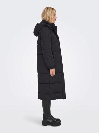 Women black longline hooded puffer coat with horizontal quilting and zip front, side view
