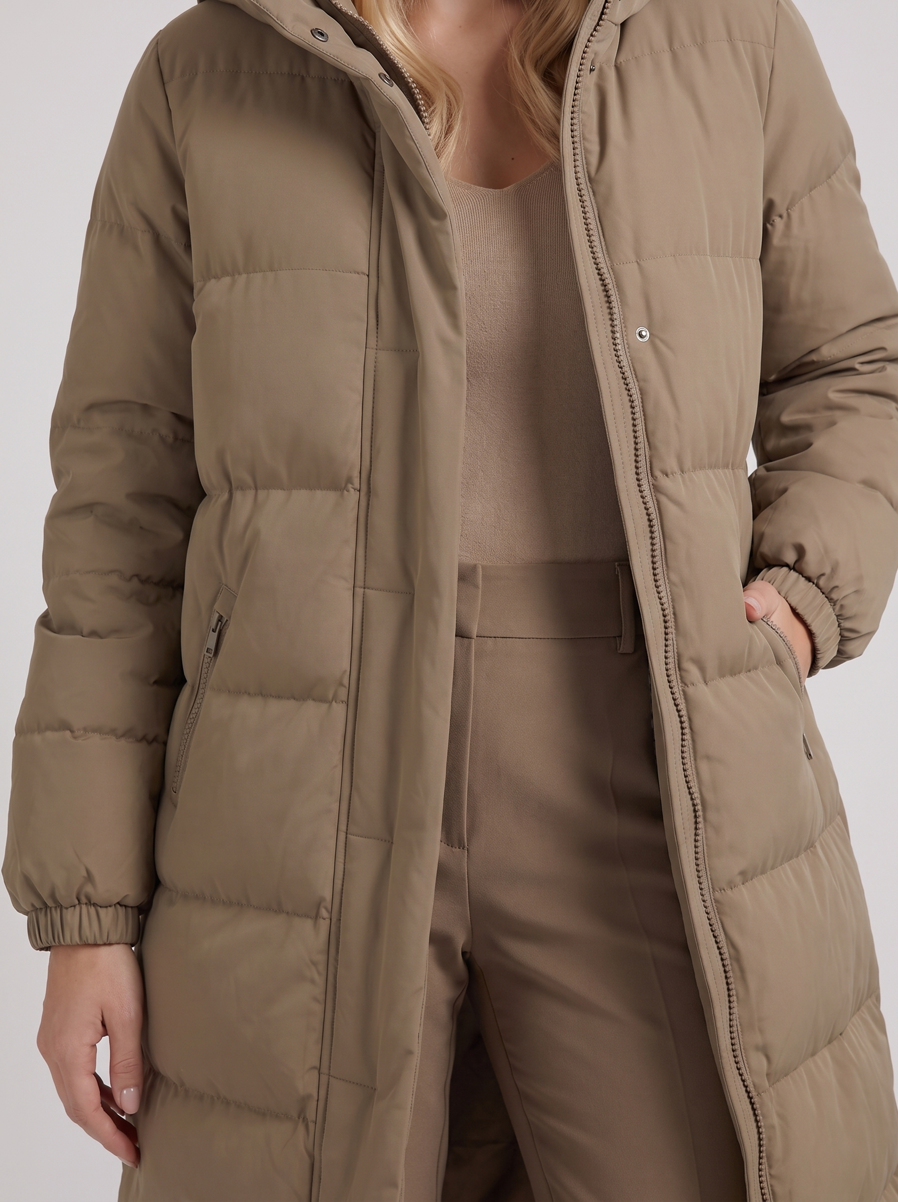 Women white longline hooded puffer coat with horizontal quilting and zip front, fabric closeup