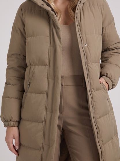 Women white longline hooded puffer coat with horizontal quilting and zip front, fabric closeup
