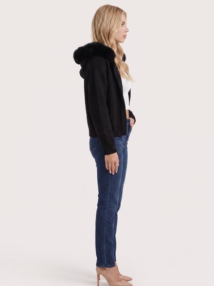 Women black hooded rib knit cardigan with faux fur pompom ties and open front, side view