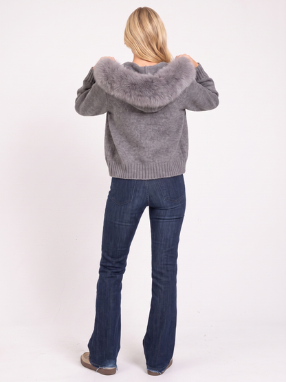 Women gray hooded rib knit cardigan with faux fur pompom ties and open front, back view