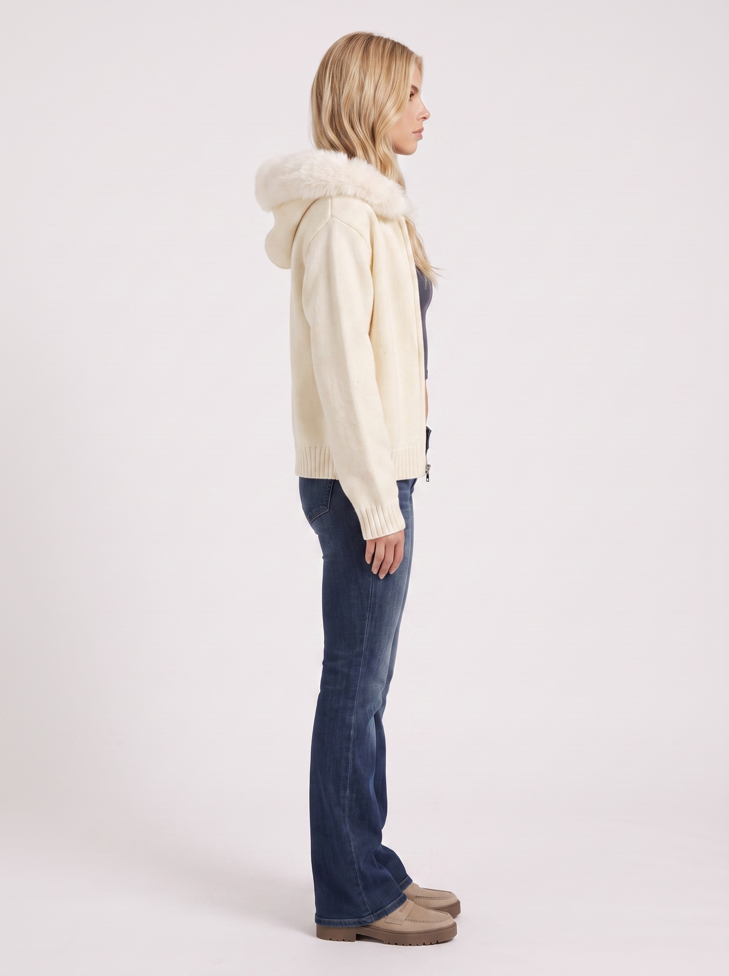 Women white hooded rib knit cardigan with faux fur pompom ties and open front, side view