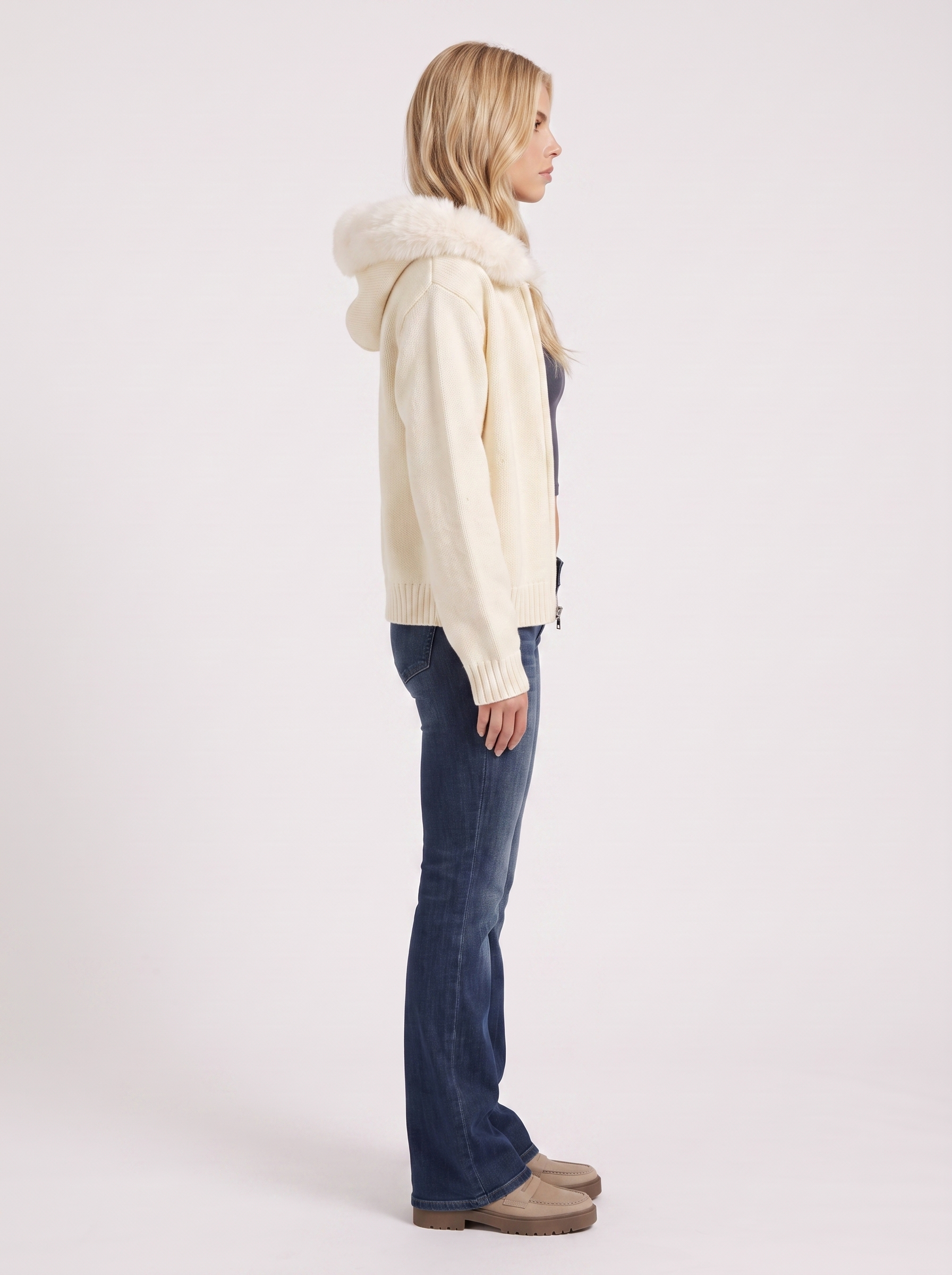 Women white hooded rib knit cardigan with faux fur pompom ties and open front, side view