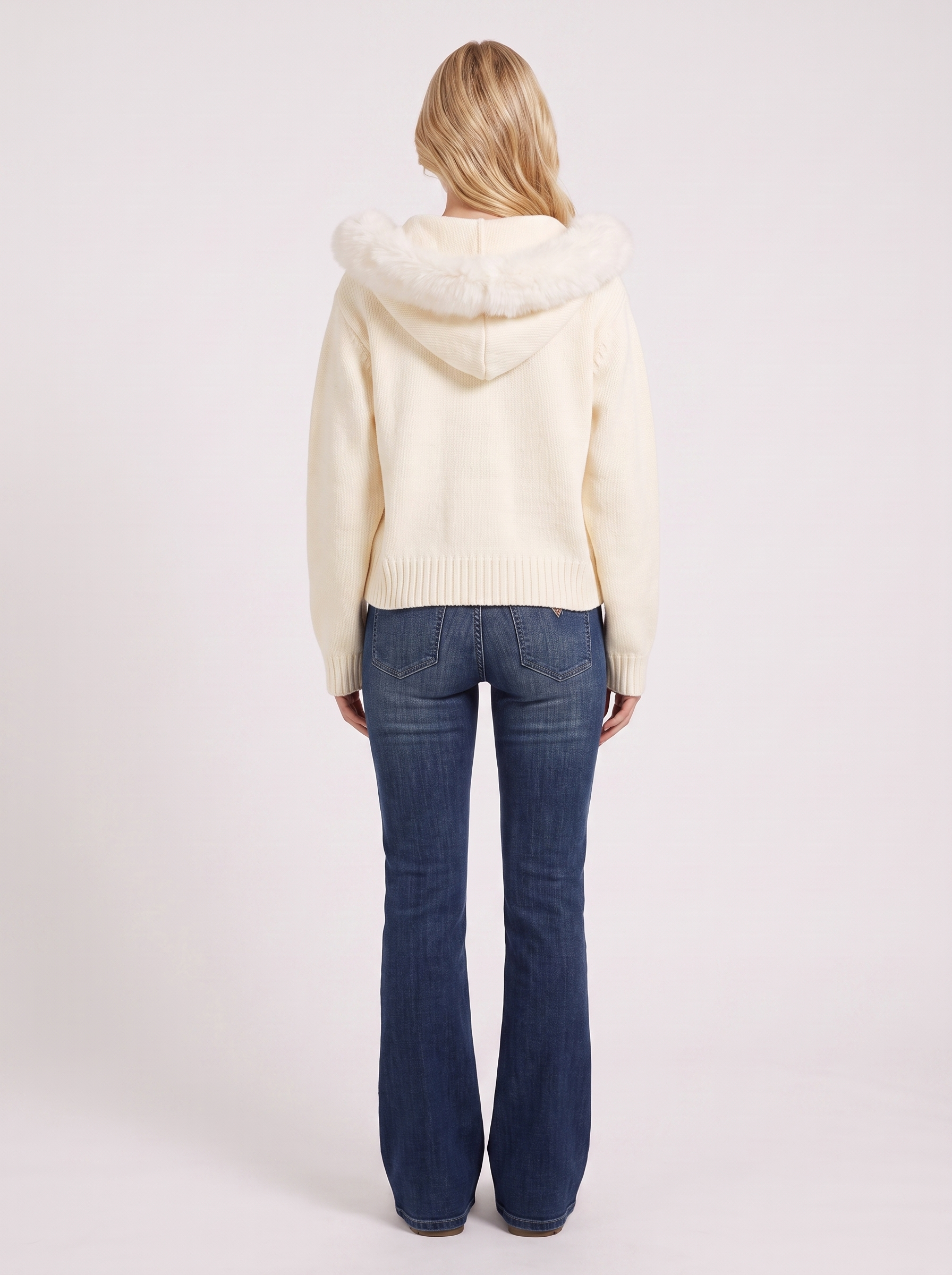 Women white hooded rib knit cardigan with faux fur pompom ties and open front, back view