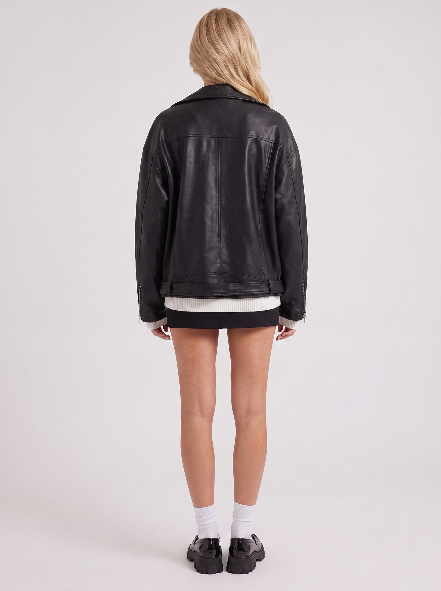 Women black oversized faux leather biker jacket with asymmetric zip and studded belt, back view