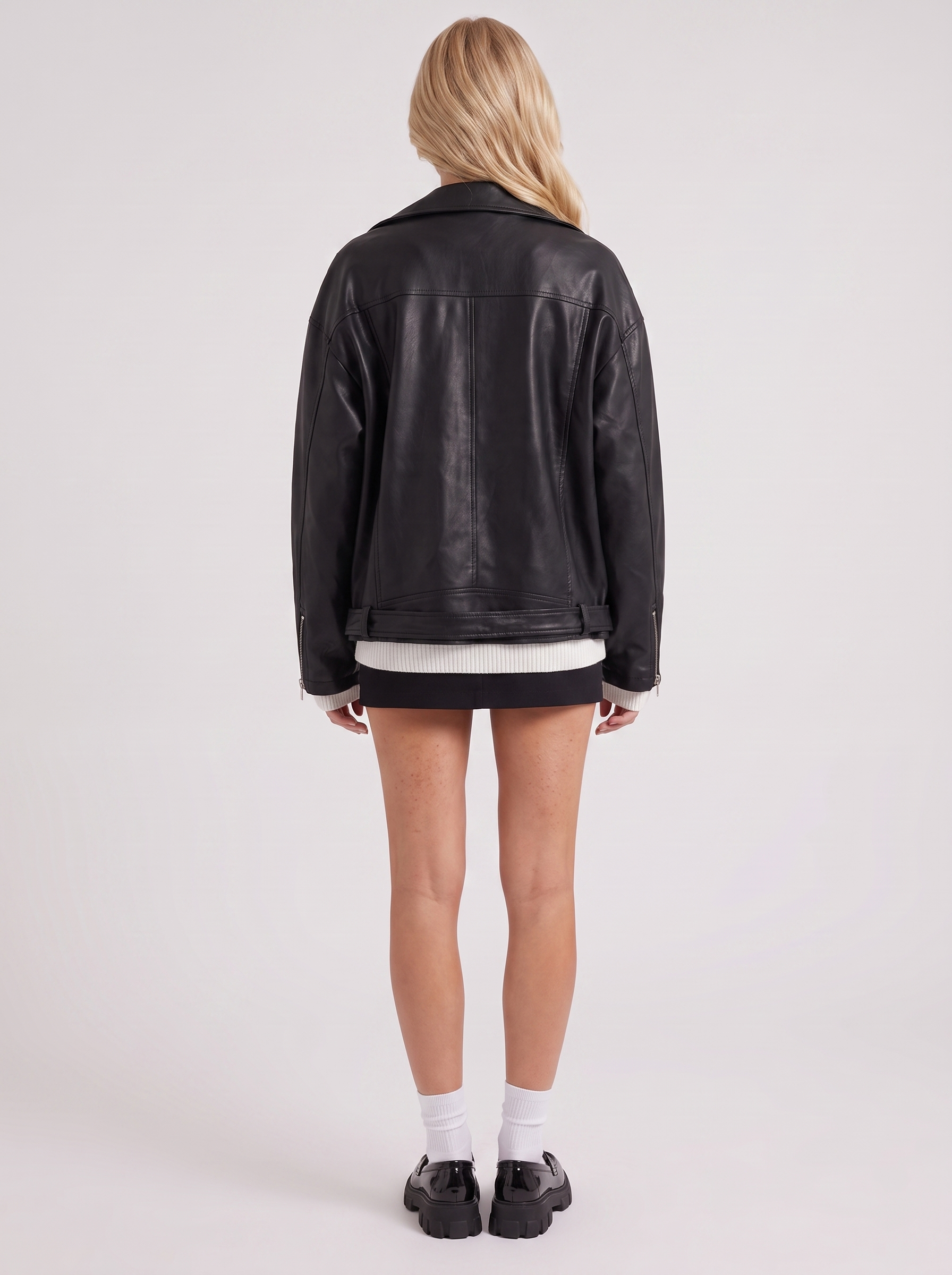 Women black oversized faux leather biker jacket with asymmetric zip and studded belt, back view