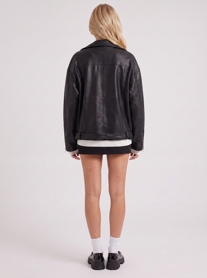 Women black oversized faux leather biker jacket with asymmetric zip and studded belt, back view