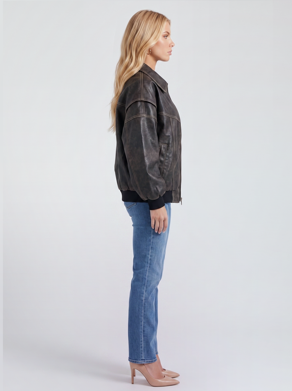 Women black oversized leather look bomber jacket shown from the side