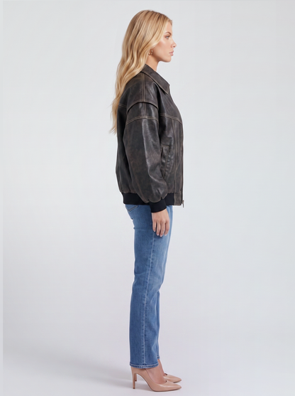 Women black oversized leather look bomber jacket shown from the side