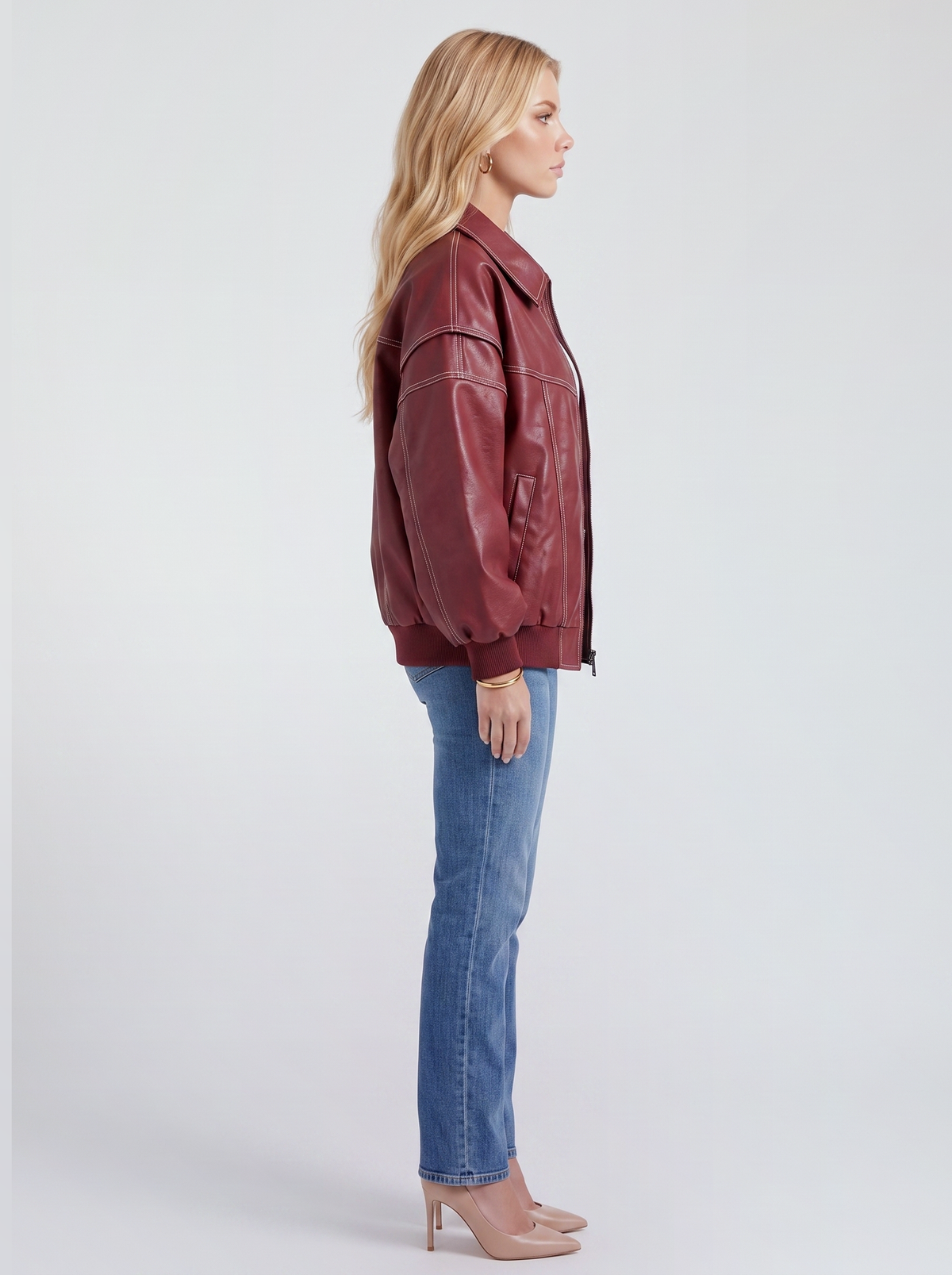 Women red oversized leather look bomber jacket shown from the side