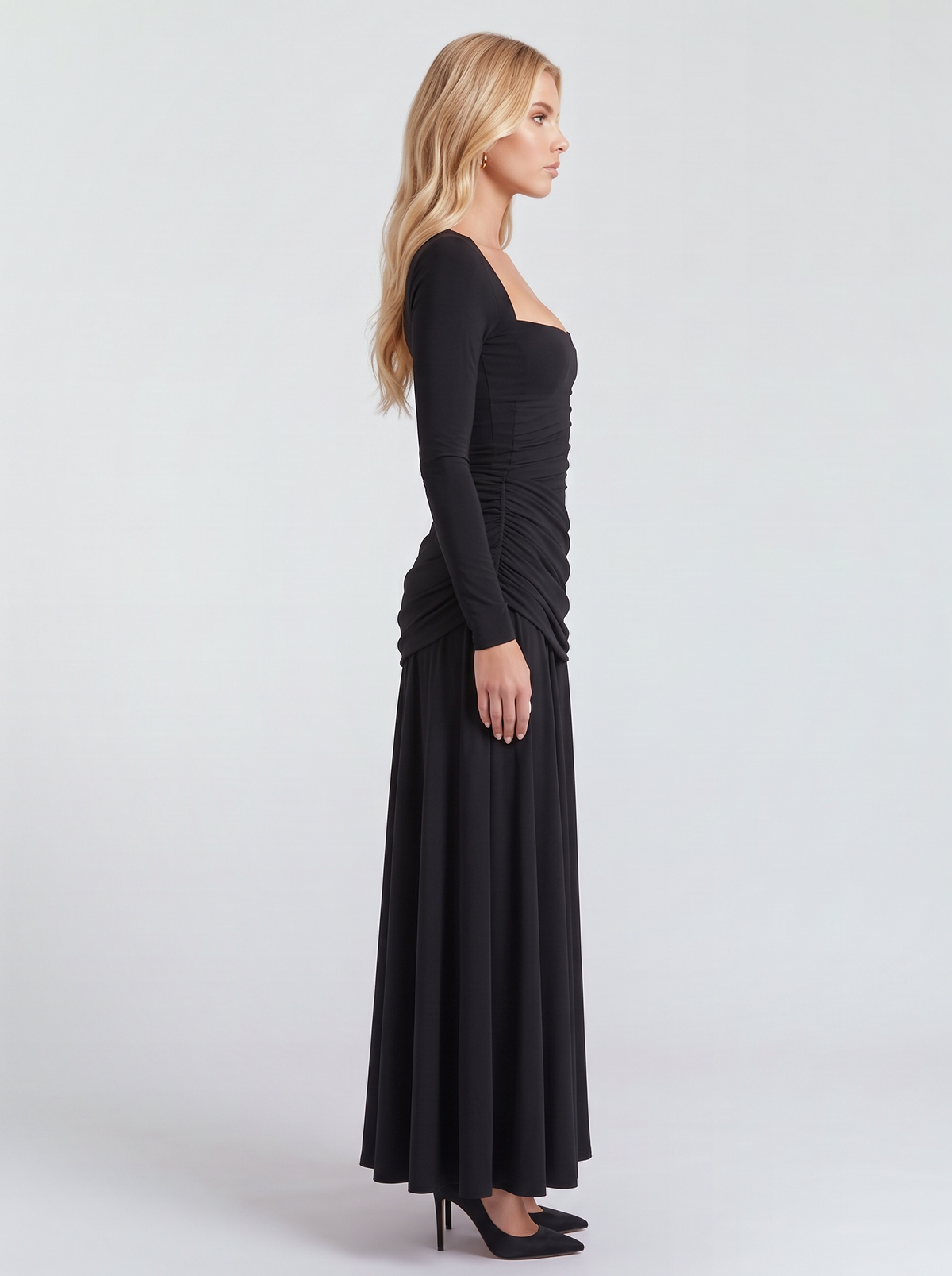 Women black long sleeve ruched maxi dress with a fitted bodice and a flowing skirt, side view